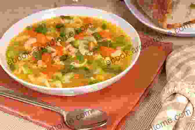 A Bowl Of Steaming Chicken Soup With Vegetables, A Comforting Remedy For Colds And Flu Learn The Art Of Cooking Soup: 80 Cozy Recipes For Creative Plant Based Soups And Stews To Share