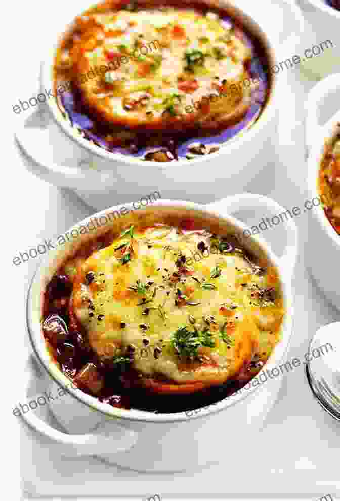 A Bubbling Casserole Dish Of French Onion Soup, Topped With Melted Gruyère Cheese And Toasted Bread Learn The Art Of Cooking Soup: 80 Cozy Recipes For Creative Plant Based Soups And Stews To Share